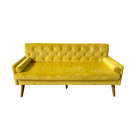 Bright yellow sofa with diamond tufted back, two small rolled pillows on the arms and wooden slanted legs.