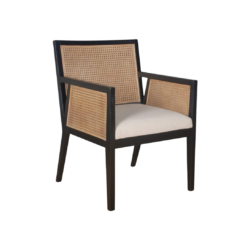 Dark wooden chair with strong angles. Cane on back and arms. Cream upholstered seat.