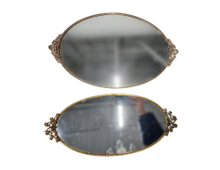 Two oval mirrored serving trays with ornate gold trim.