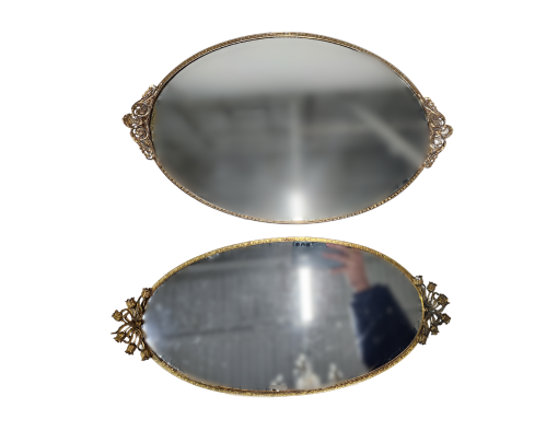 Two oval mirrored serving trays with ornate gold trim.