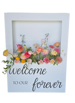 White rectangular box with a cut out for flowers. Bright colored flowers from the box and custom vinyl on the bottom